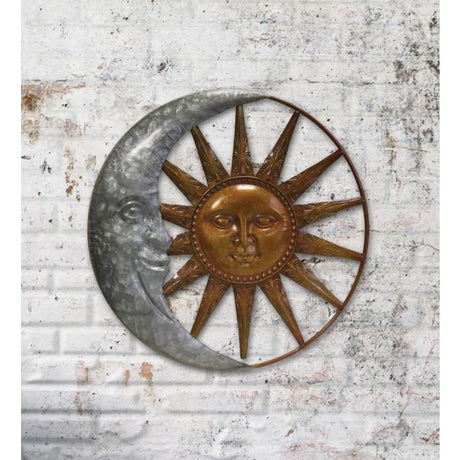 a galvanized metal crescent moon encircling a bronze sun installed on a white brick wall