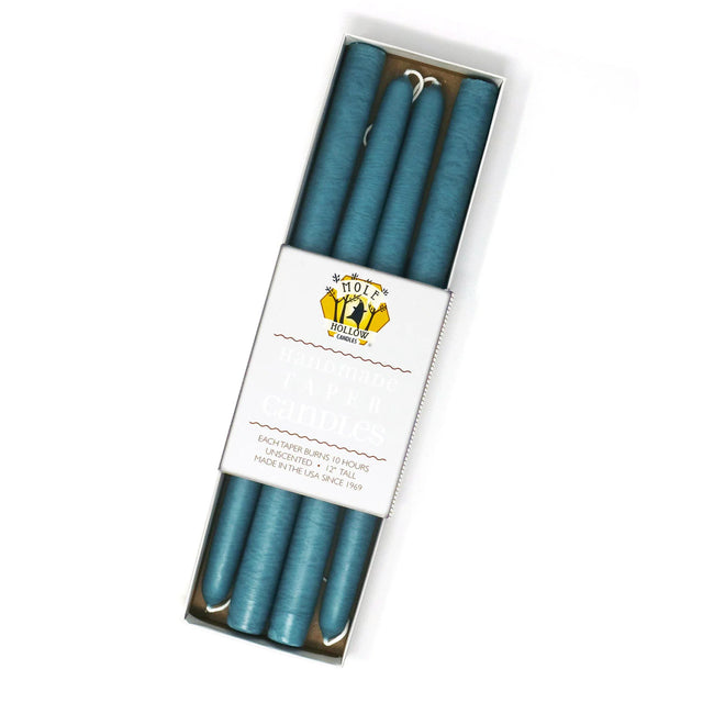four colonial blue taper candles in a rectangular box with a white label