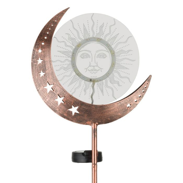 Close-up of solar garden stake with crescent moon and star design