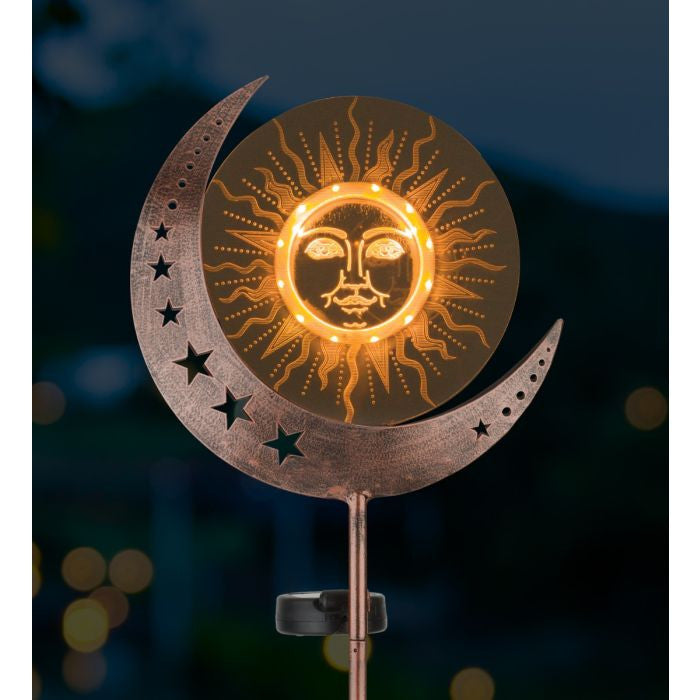 Solar garden stake with crescent moon and star in garden