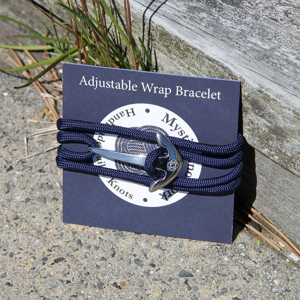 the packaging for the adjustable wrap bracelet wrapped around a navy blue card that says "Mystic Knotwork" - navy blue packaging bracelet shown as example