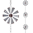 Decorative metal windmill hanging from chains on a white background