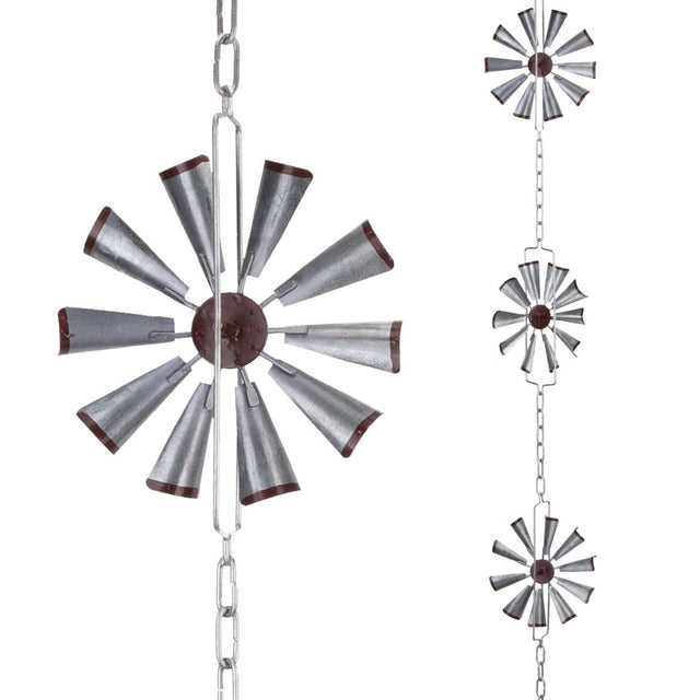 Decorative metal windmill hanging from chains on a white background