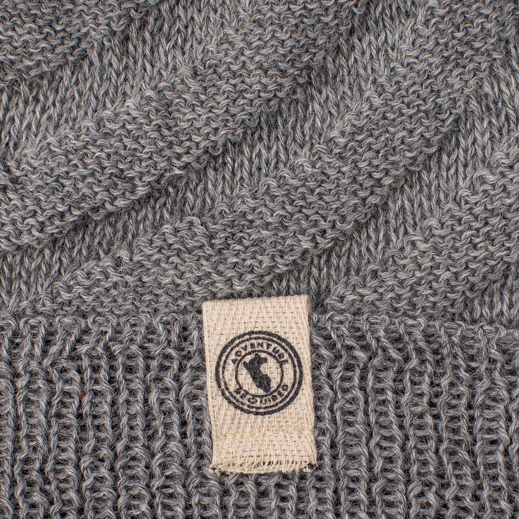 a close up of the gray Kingsley alpaca hat highlighting the cream colored label on the fold of the hat and the detailed diagonal stitch pattern of the hat