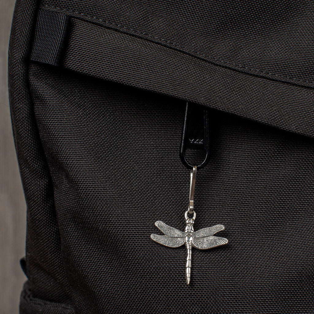 dragonfly zipper pull on a black backpack zipper