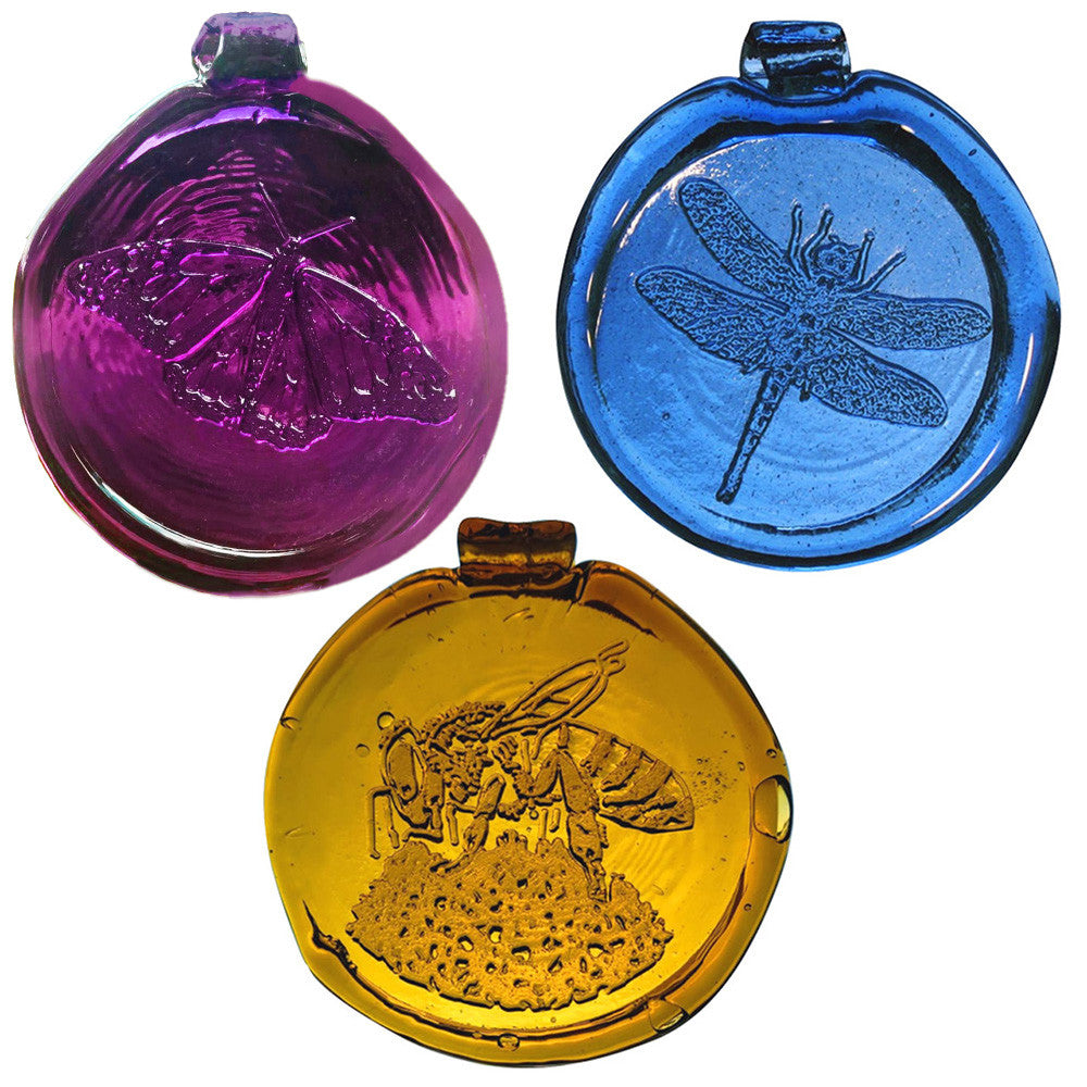 a trio of round, glass suncatchers: an amethyst purple butterfly, a blue dragonfly, and a yellow bee