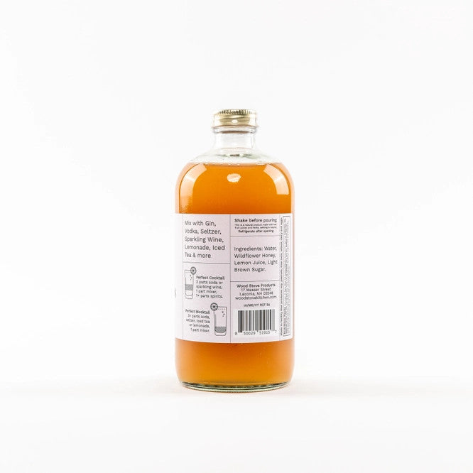 back view of Bee's Knees Mixer bottle featuring honeycomb design on label directions for use and ingredients