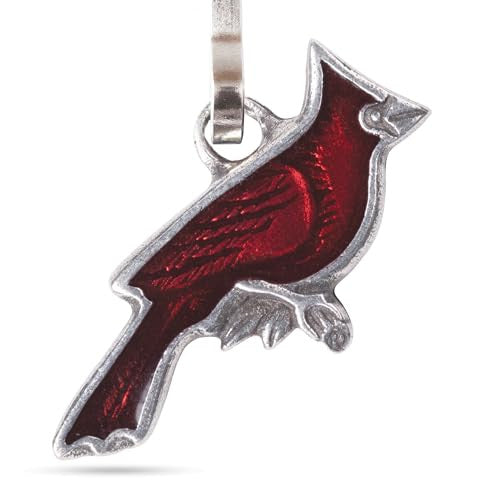 A close up of the detail of the pewter zipper pull in the shape of a brilliant red cardinal in profile hanging from a clip to affix it to any zipper