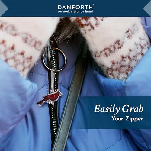 close up of the cardinal zipper pull on a powder blue coat, text at the top of the image reads "Danforth Pewter: we work metal by hand" and "Easily grab your zipper"