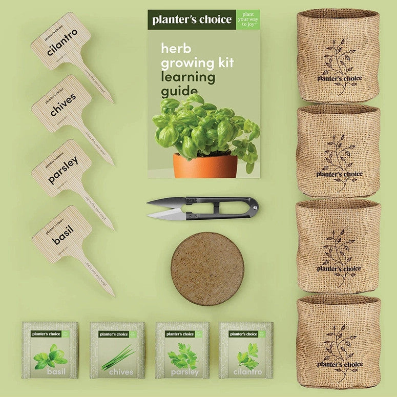 The entire contents of the kit fanned out so you can see the detail of each: 4 burlap pots, 4 plant markers marked with all of the plant names, 4 seed packets, 1 soil disk, herb snips, and the growing guide