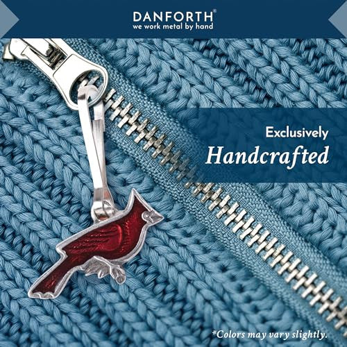 the cardinal zipper pull on a light blue cable knit sweater with a silver sipper with text that reads "Danforth Pewter: we work metal by hand" and "exclusively handcrafted"