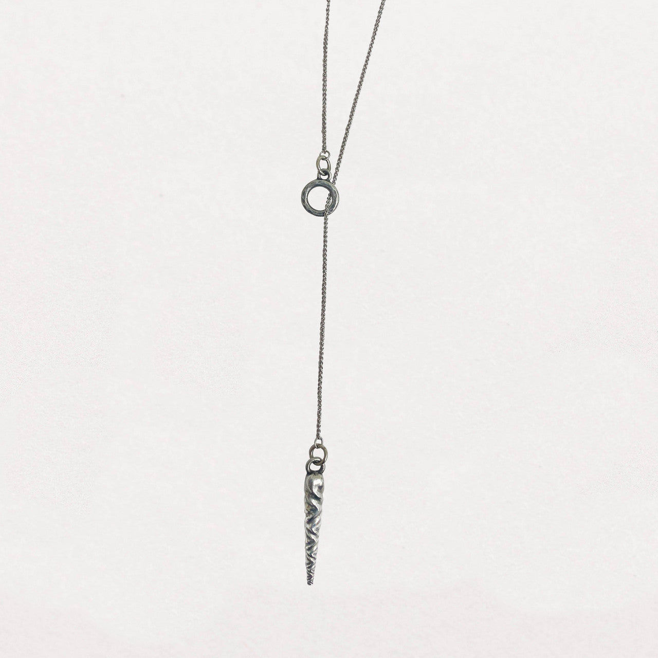 Stylish pewter icicle pendant necklace on an 18-inch sterling silver lariat chain, featuring a subtle, elegant design inspired by vintage Bakelite ornaments against a white background