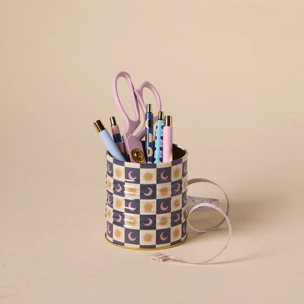 Checkered container with stationery items on a beige background
