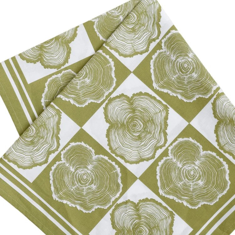 folded bandana with tree ring pattern on a green and white checkered background