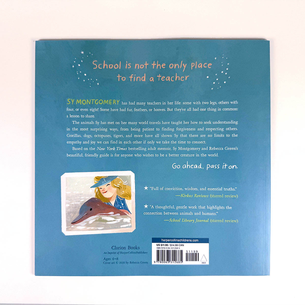 Book back cover with text and illustration of a girl with a dolphin on a blue background