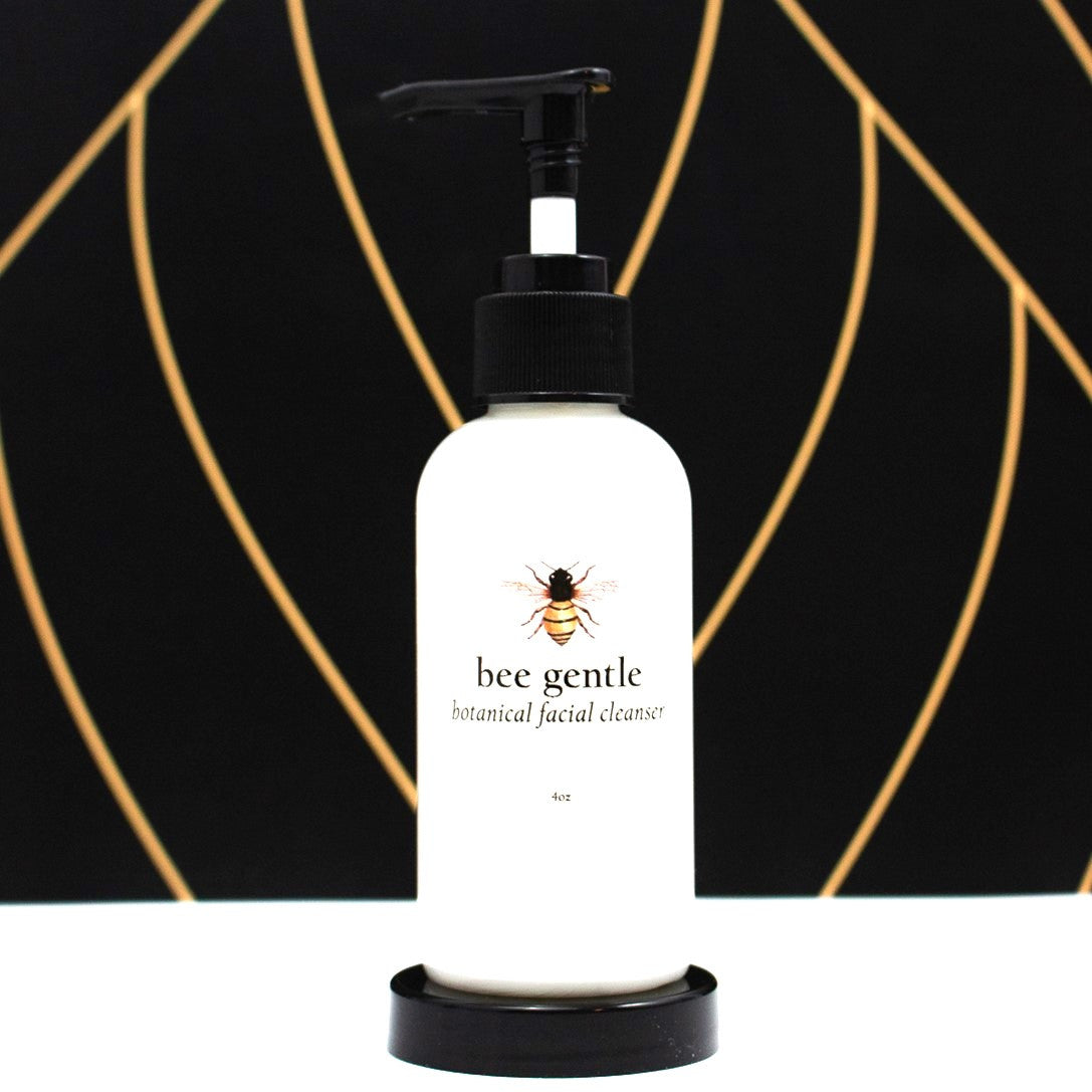 The Bee Gentle cleanser bottle; a white bottle with bee illustration above the text "Bee Gentle" with a black pump at the top of the bottle.