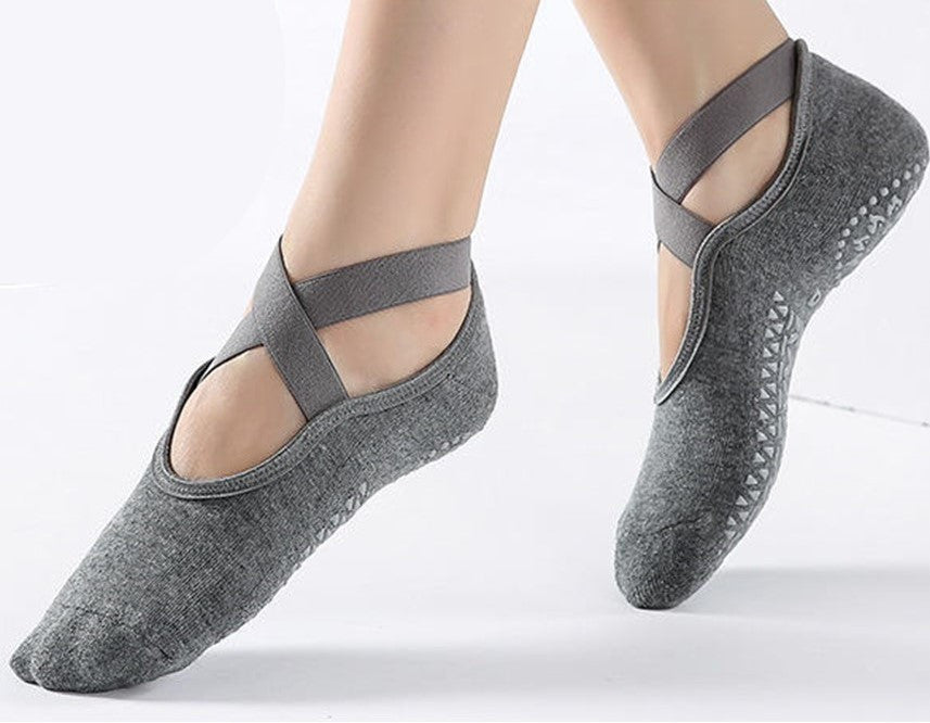 a pair of feet mid-step wearing the gray, 100% cotton socks