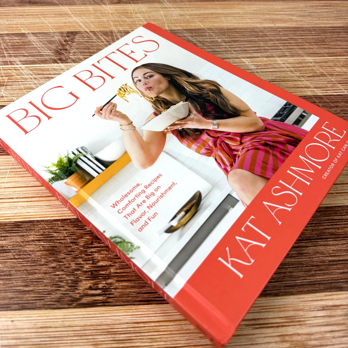 Book titled 'Big Bites' by Kat Ashmore on a wooden surface