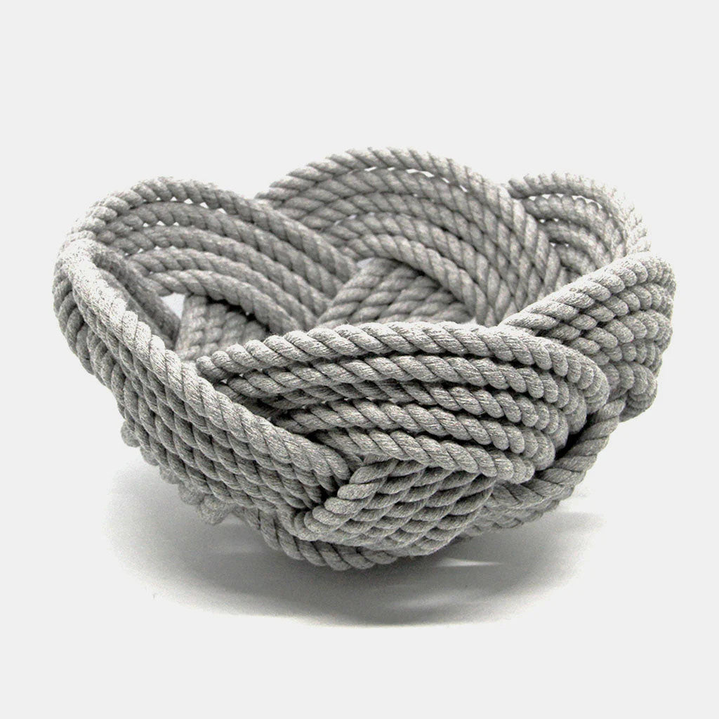 a hand woven cotton rope bowl in gray against a white background