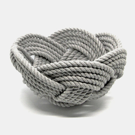 a hand woven cotton rope bowl in gray against a white background