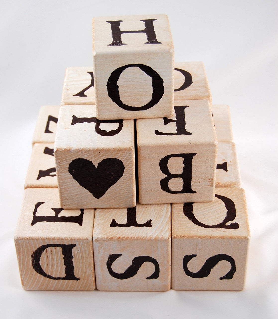 a pyramid of lettered blocks