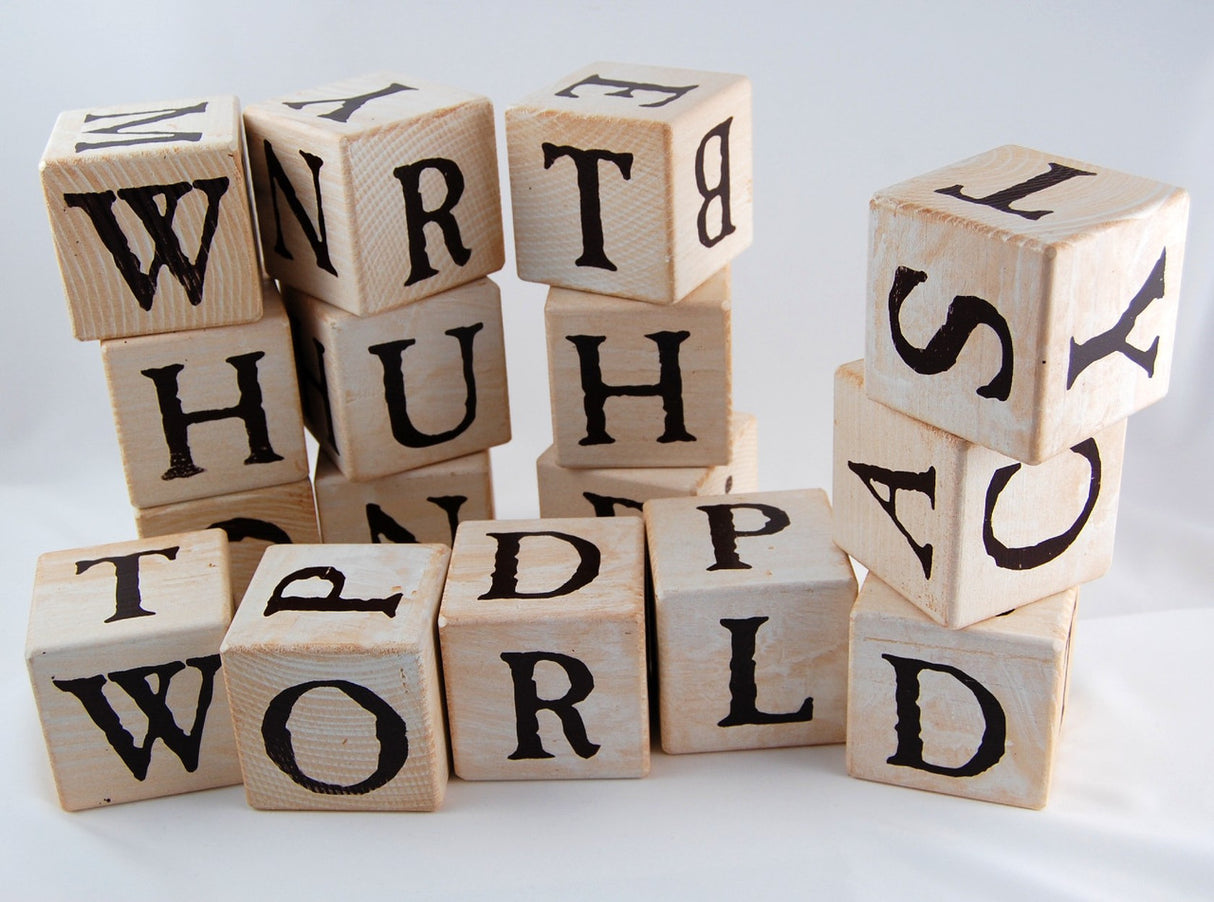 a random assortment of lettered blocks stacked and piled together