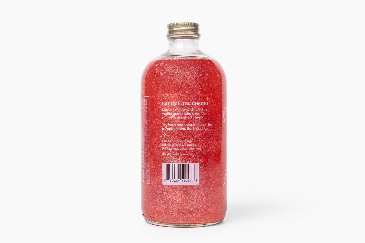 Bottle with red glittery liquid and gold cap on a white background