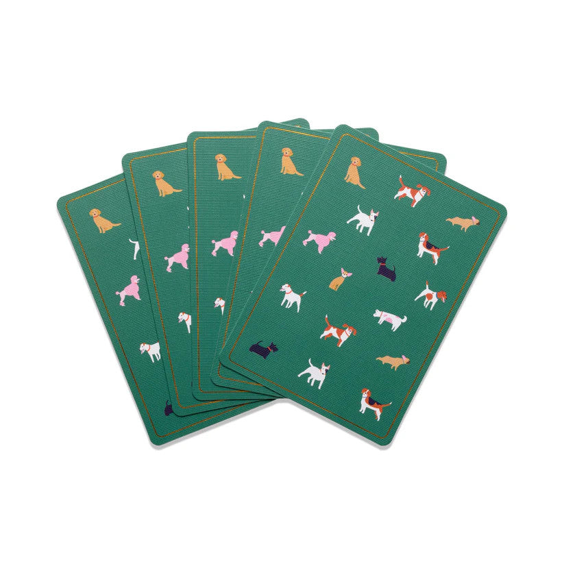 Several of the Dogs playing cards fanned on a white surface showing the artwork featuring several dog breeds against an emerald green background