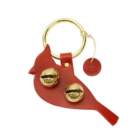 a door hanger bell in red leather stamped in the shape of a cardinal in profile - includes 2 brass bells in the body of the bird and a brass loop for hanging on a door