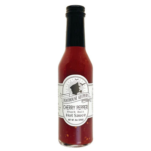 a tall slender bottle of cherry pepper hot sauce