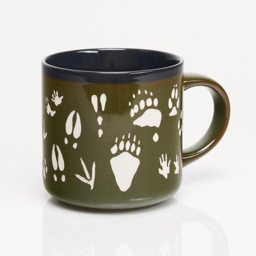 the other side of a deep green coffee mug with various animal tracks in white including paw prints, hoof prints, birds, and more
