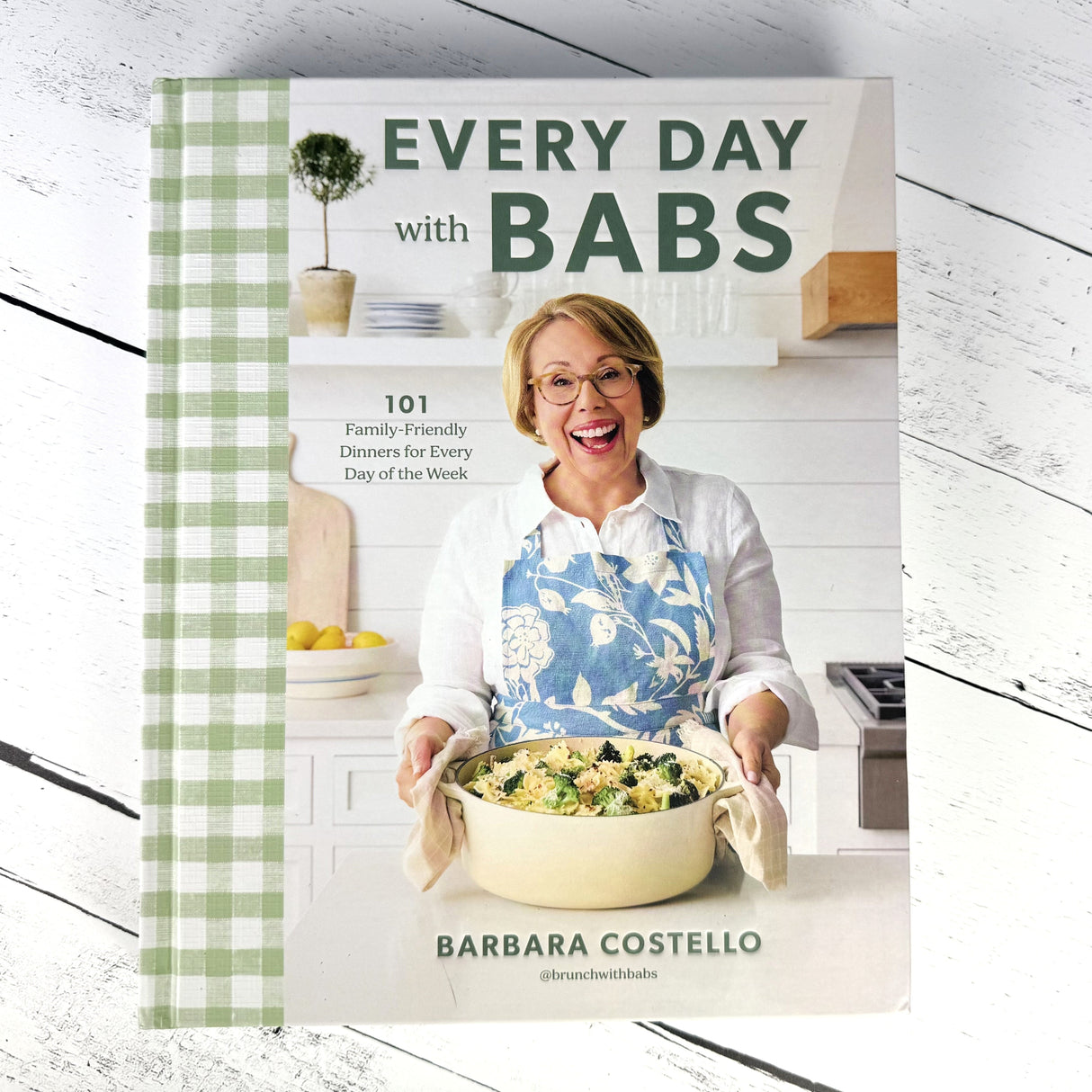 Cookbook titled 'Every Day with BABS' by Barbara Costello on a white wooden surface.