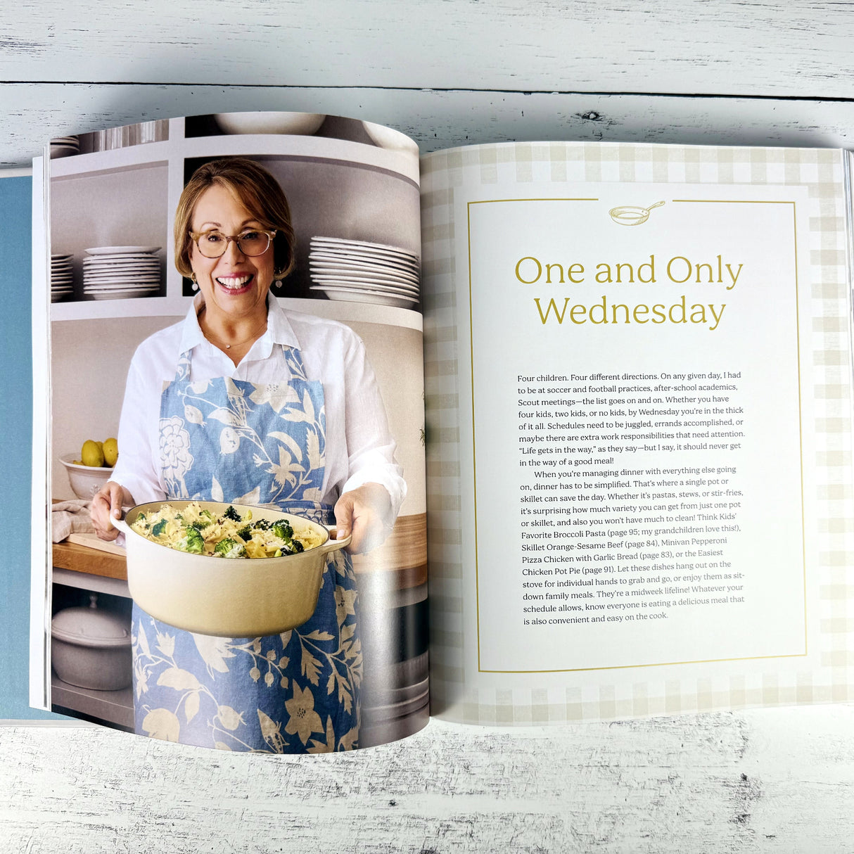 Open book showing a woman holding a bowl of food in a kitchen setting