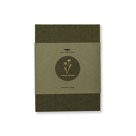 the field press with green linen cover and gold foil floral detail, comes in a hemp paper wrap