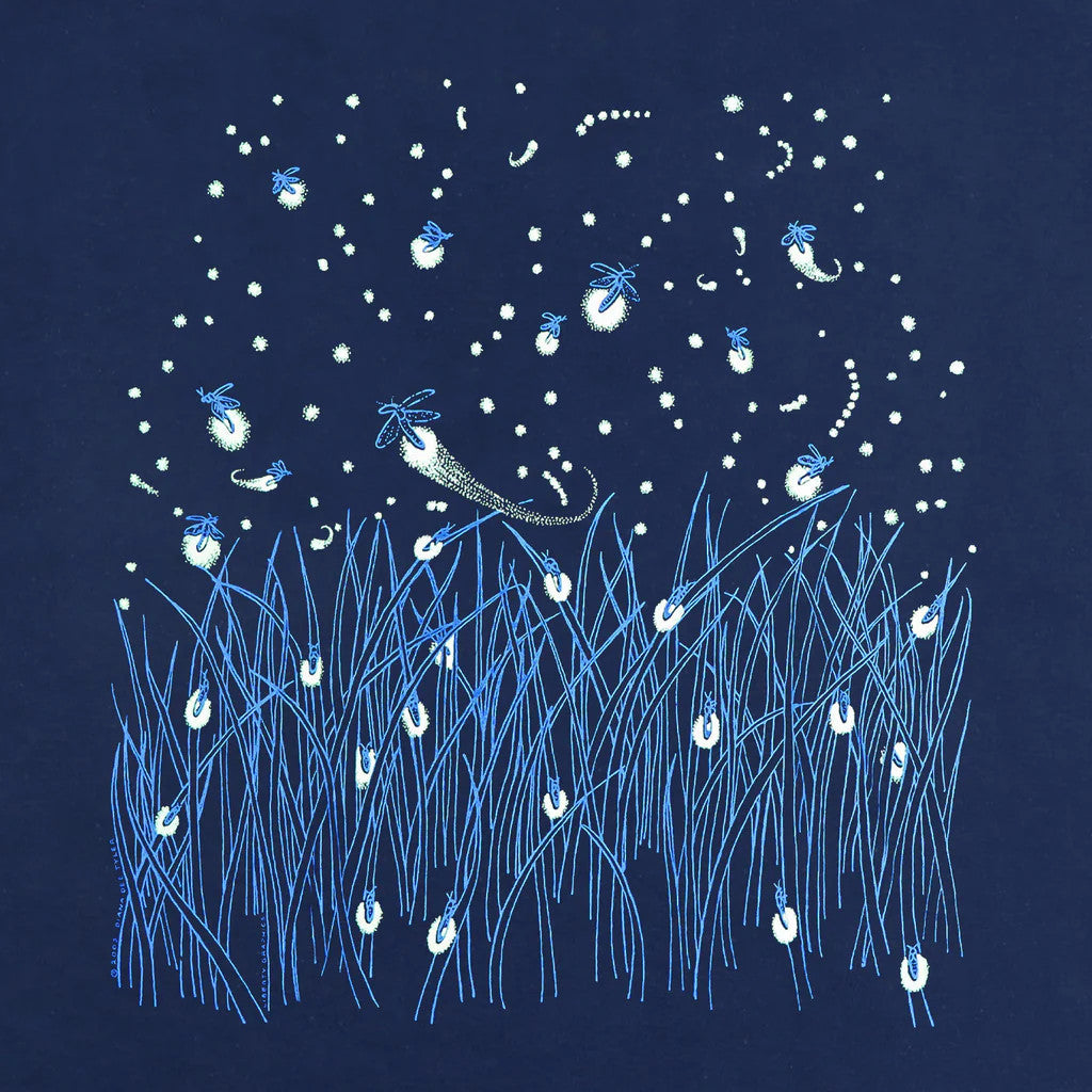 close up of the tee shirt illustration of a grassy field with fireflies and stars dotting the landscape