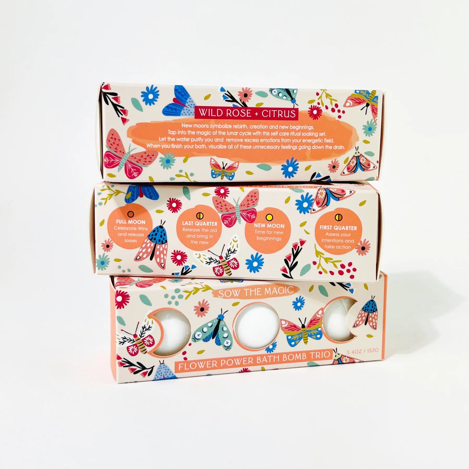 Three stacked boxes of Wild Rose Citrus bath bombs with colorful designs on a white background