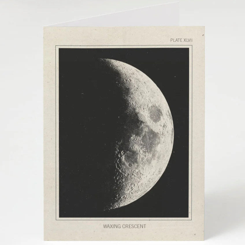 an off white greeting card with a vintage image of the moon in its waxing crescent phase
