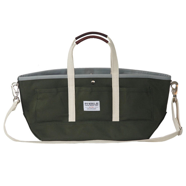 a wide olive green canvas tote with white straps and leather handles against a white background
