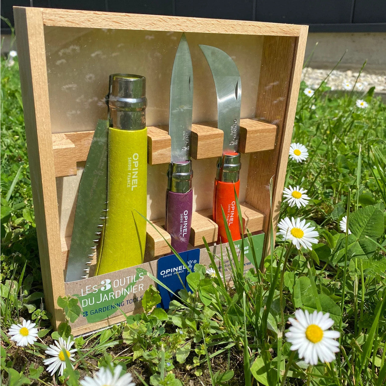 the Garden Gift Box in its package resting amongst blades of grass and daisies