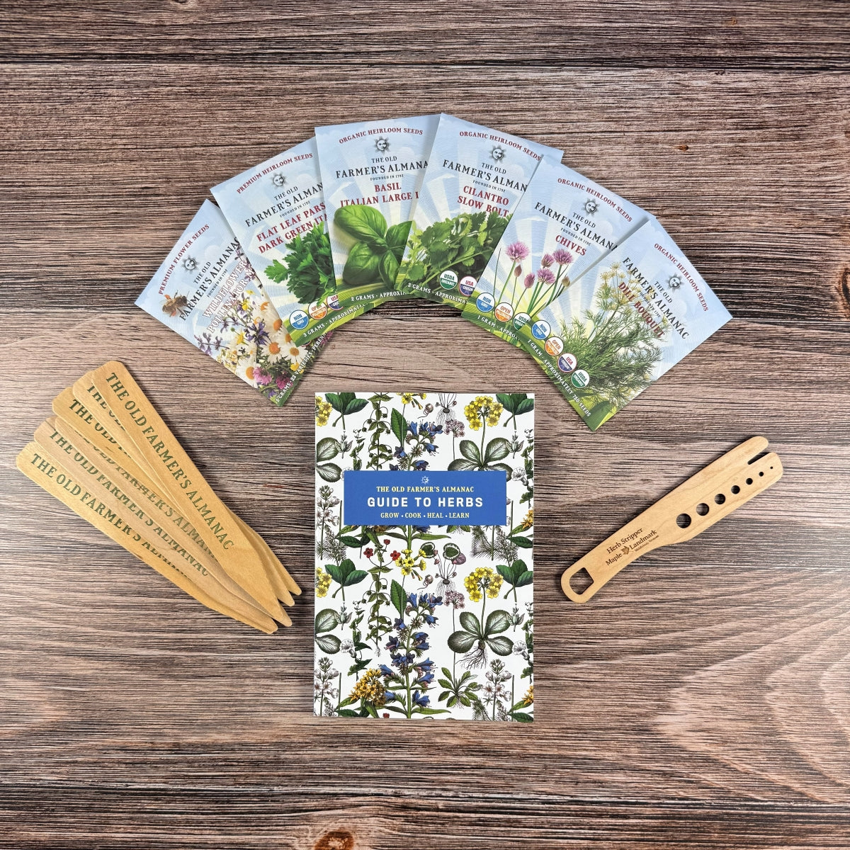 Set of seed packets and a guidebook on a wooden surface