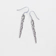 pewter icicle earrings laying flat on a white background