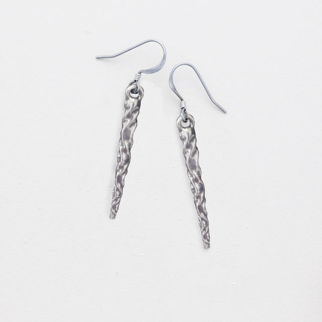 pewter icicle earrings laying flat on a white background