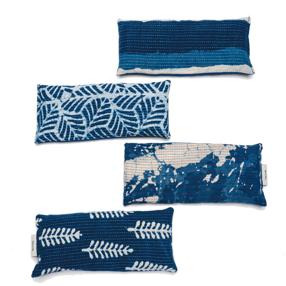 a vertical stack of each available color/pattern of the indigo eye pillows