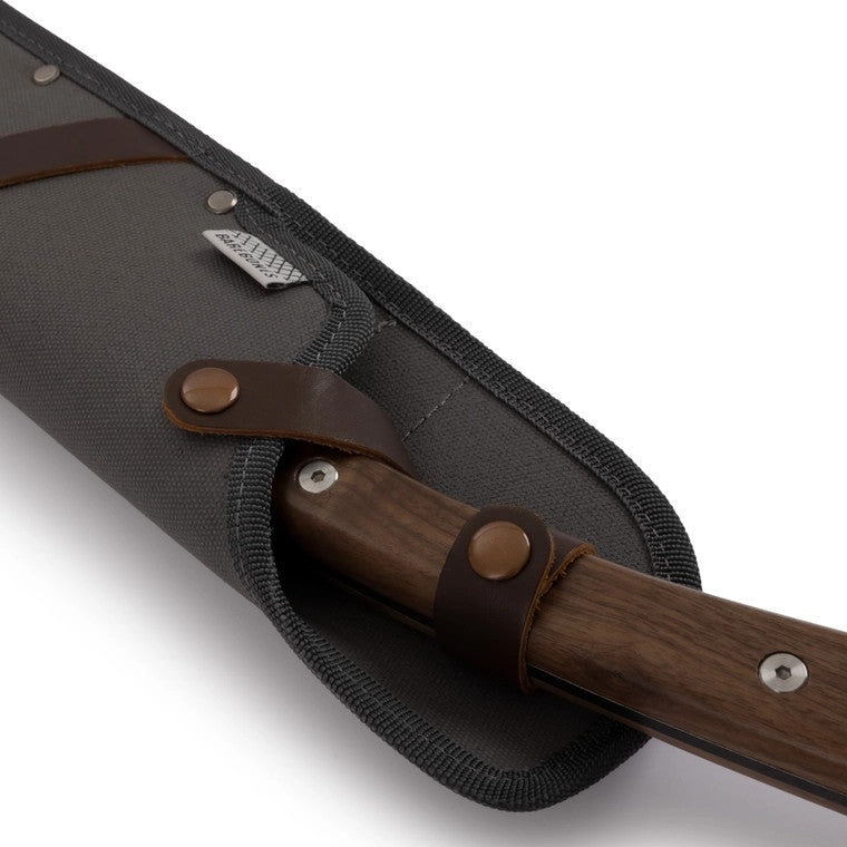 a close up of the handle of the japanese nata hatchet secured in its sheath showing the two clips that hold it securely in place