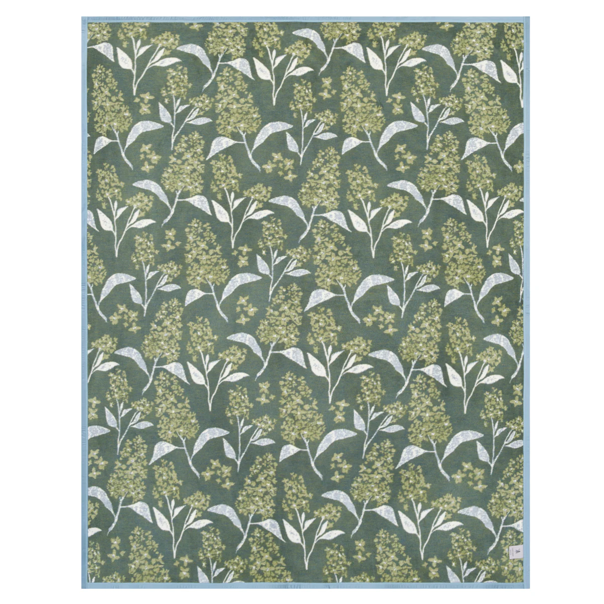the reverse side of the lilacs blanket with green and white leaves on a green background