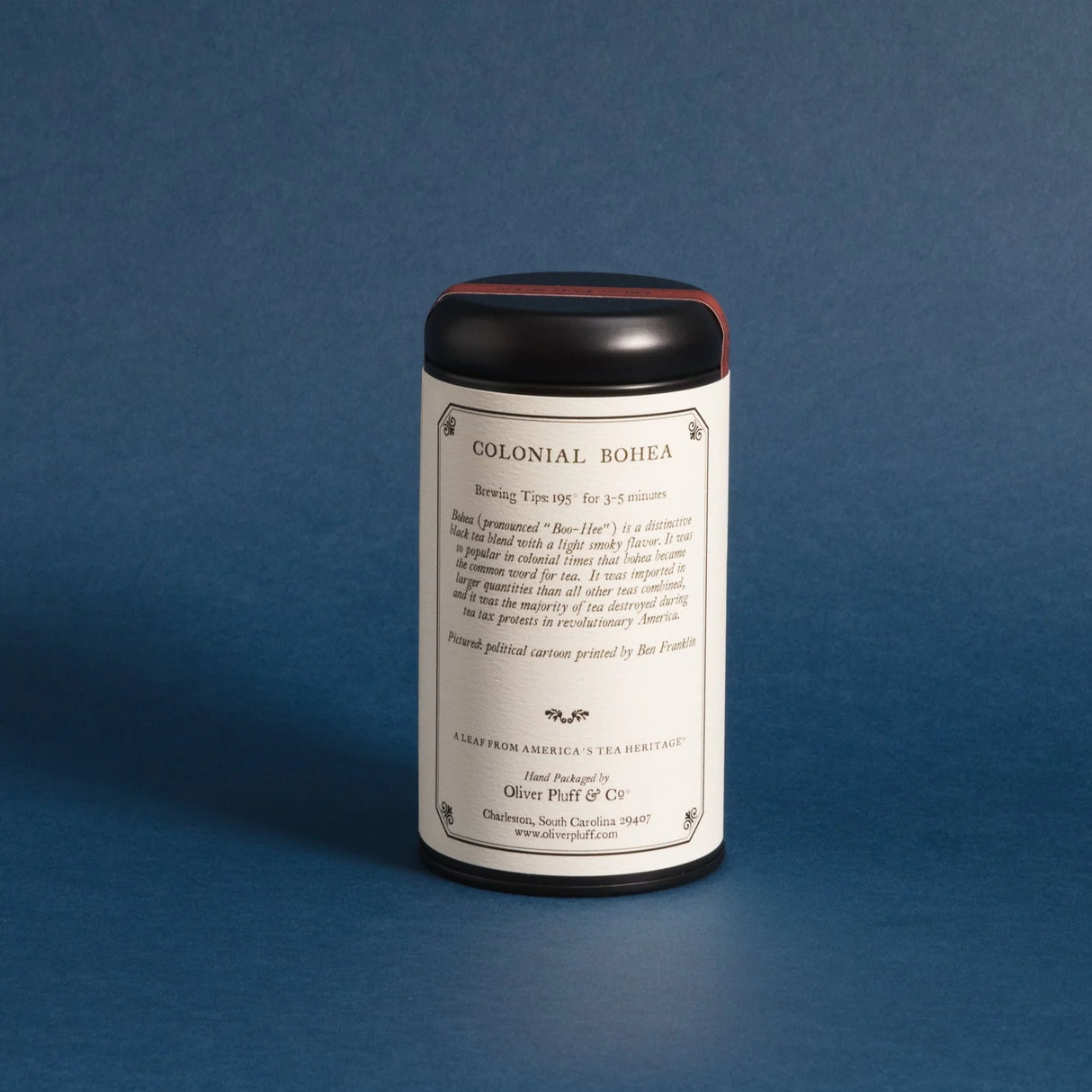 Colonial Bohea tea tin showing the back label against a deep blue background