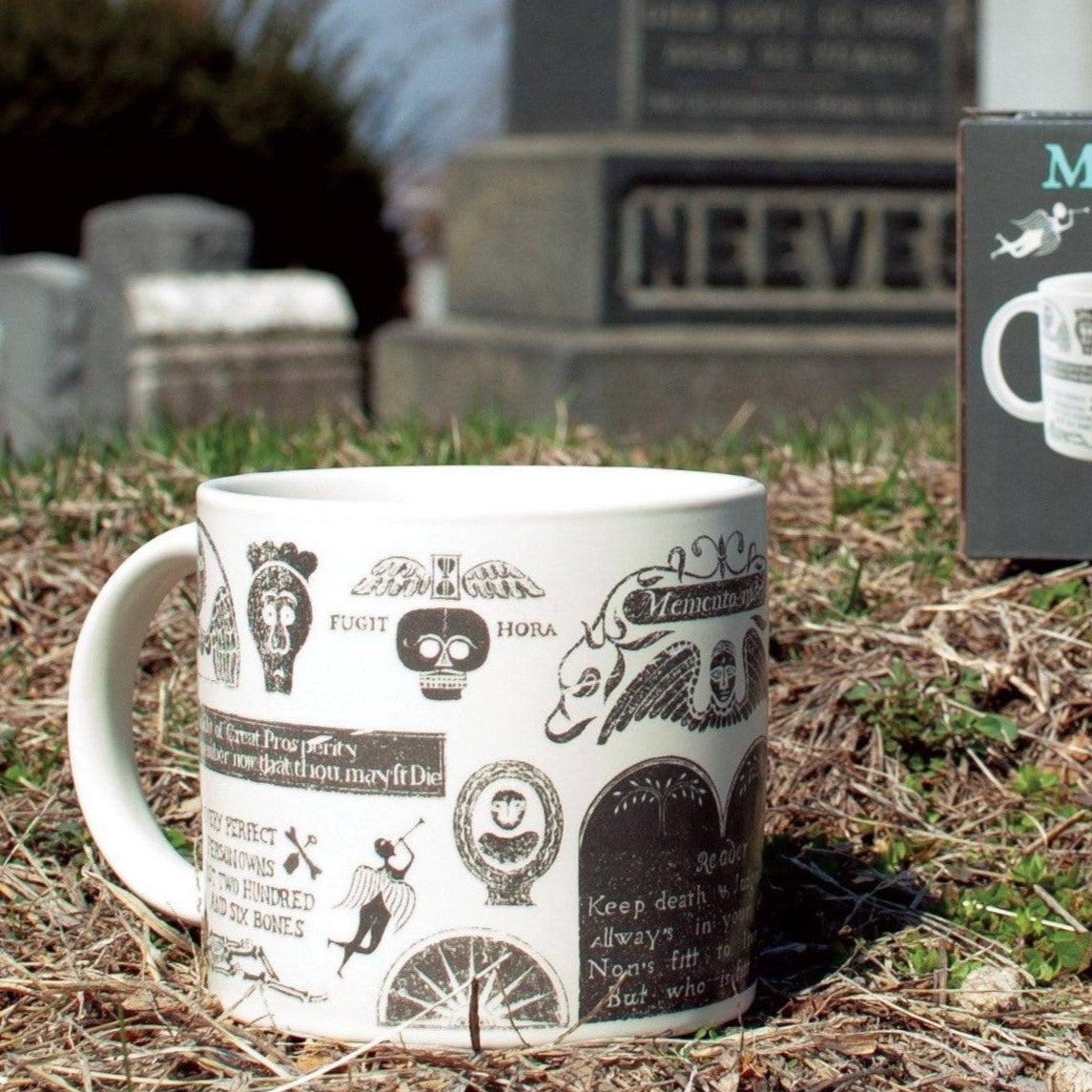 Memento Mori mug with decorative design in front of a gravestone
