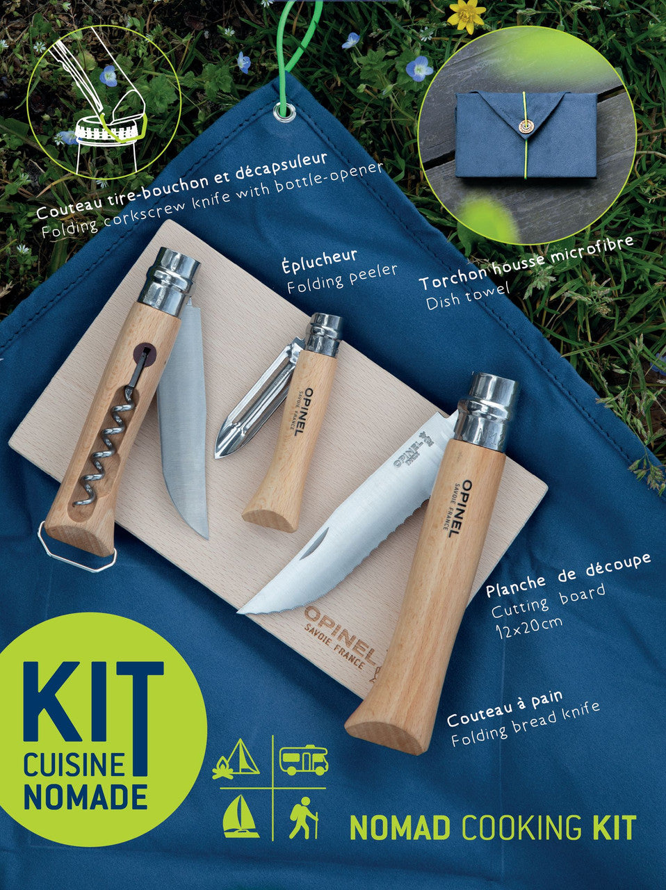 The Nomad Cooking kit with items laid out on the cutting board on top of the cloth on the grass