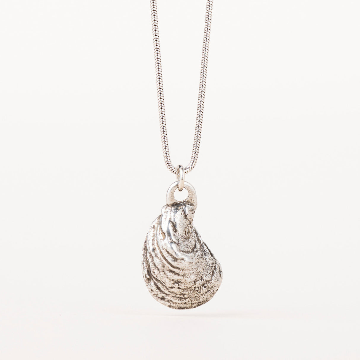 Silver Oyster Shell Necklace with a pendant molded from a real oyster shell, featuring outer shell detail