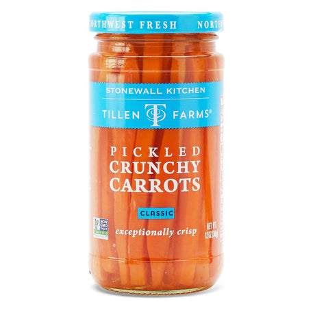 a tall narrow jar of bright orange pickled carrots with a sky blue lid